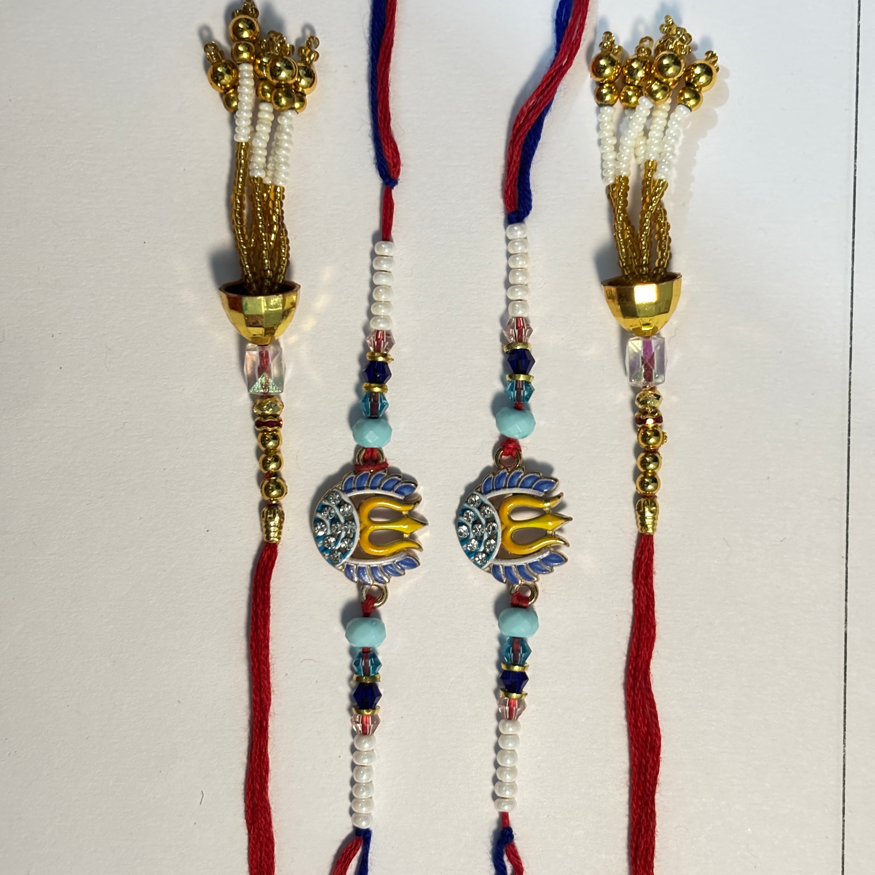Spiritual Trishul & Gold Tassel Bhaiya Bhabhi Rakhi Set (Pack of 4)