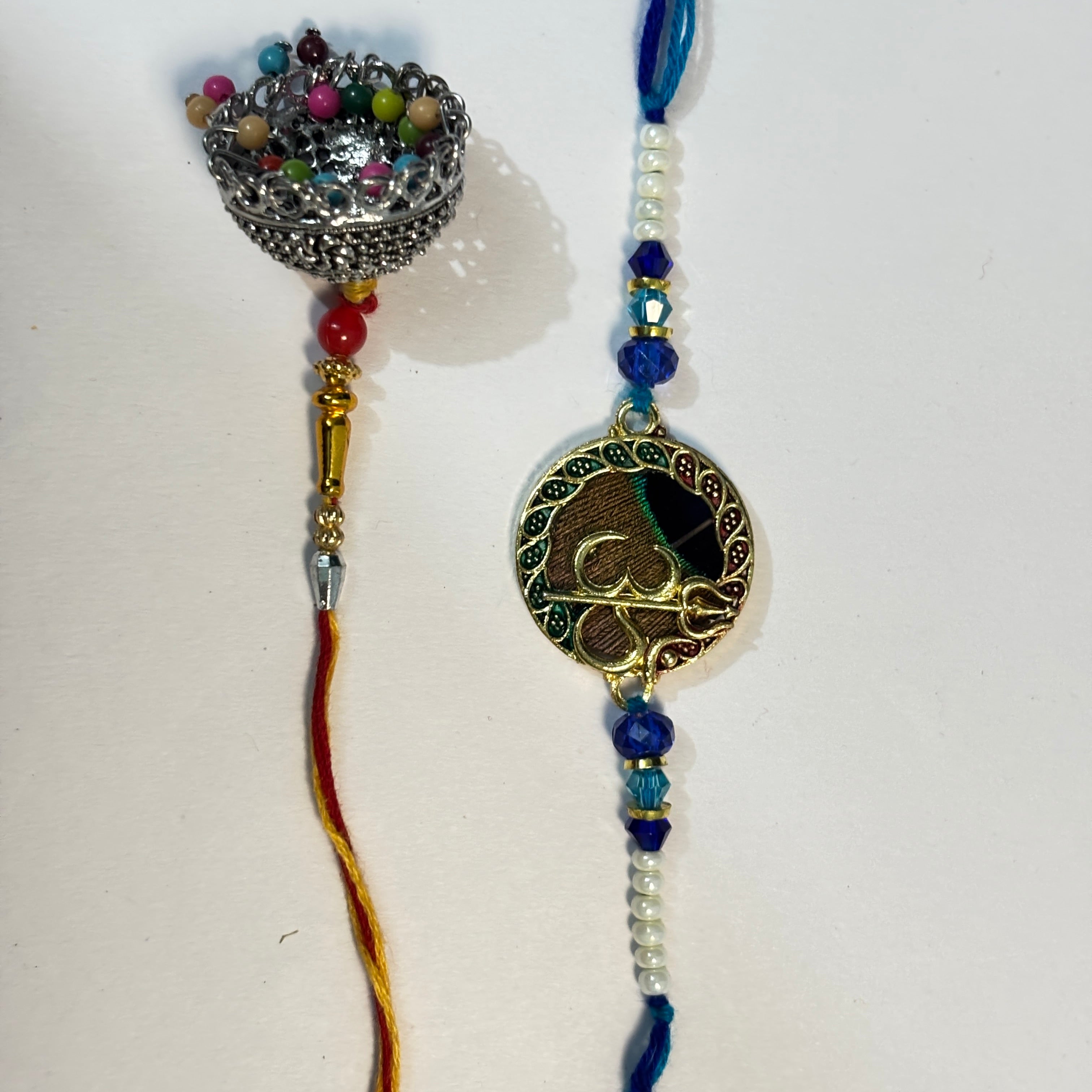 Om & Peacock Feather Bhaiya Bhabhi Rakhi Set (Pair of 2)